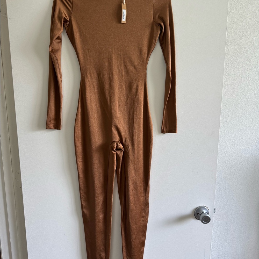 Skims ALL-IN-ONE SHINE CREW NECK LONG SLEEVE ONESIE